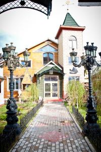 a house with two street lights in front of it at Petrovsky Dvorik in Vozdvizhenskoye