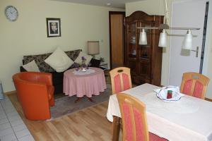 a living room with a couch and a table at Apartment Baden Baden Haus am Ibachweg in Baden-Baden
