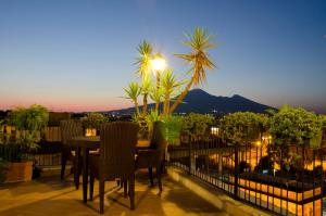 a patio with a table and chairs on a balcony at Hotel Palma in Pompei