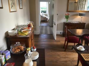 a living room with a table with food on it at Ballifeary House in Inverness