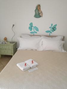 a bedroom with a bed with two towels on it at Camera Privata in Pomezia