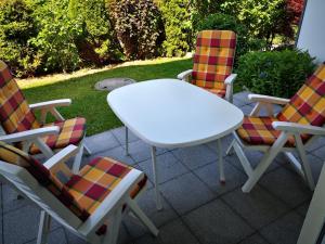 a table and two chairs and a white table and chairs at Traumblick in Kempten