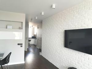 Televízia a/alebo spoločenská miestnosť v ubytovaní ORION Downtown Apartment by PinPoint