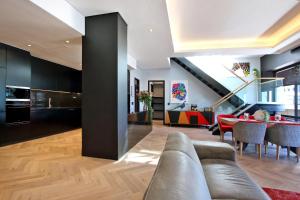 a living room with a couch and a table at Penthouse Henning@The Onyx in Cape Town