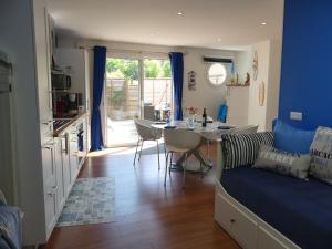 a kitchen and living room with a couch and a table at DOUCE FARNIENTE in Arès