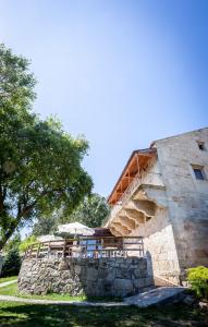 a stone building with a staircase on the side of it at Casa Rural Abadia Eiras in Rosal