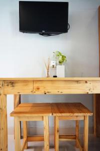 a wooden desk with a tv on top of it at Louto Dmell Villa & Guesthouse in Sanur
