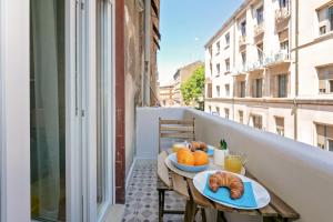 a table with two plates of food on a balcony at Preziosa in Pula