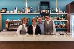 a group of people standing at a bar at HOTEL - BAR DA NATALE in Paesana