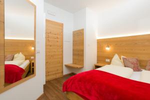 a bedroom with two beds and a mirror at Jägerhaus in Pellizzano +66 photos