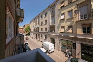 a view of a city street with a white van parked on the sidewalk at Preziosa in Pula