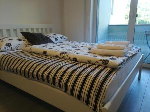 a bed with towels on it in a bedroom at Alfa Riverside Brno in Brno