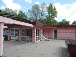 a pink house with a patio at Carpe Diem Apartment in Hajdúszoboszló