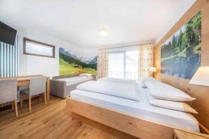 Postel nebo postele na pokoji v ubytování Hotel Garni Morene