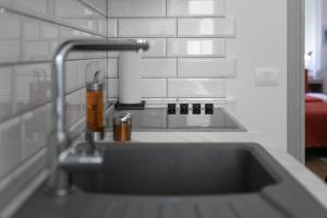 a kitchen sink with a faucet in a kitchen at La Preziosa Rooms in Pula +37 photos