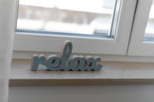 a wooden word koala sitting in front of a window at La Preziosa Rooms in Pula