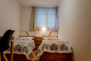 a bedroom with two beds and a window at Apartment Katia in Pula