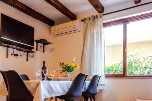 ein Esszimmer mit einem Tisch mit Stühlen und einem Fenster in der Unterkunft Apartment Katia in Pula