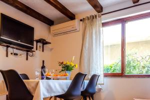 a dining room with a table with chairs and a window at Apartment Katia in Pula