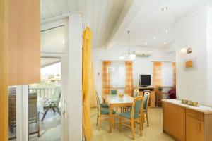 a kitchen and dining room with a table and chairs at Put Maslina 7 in Savudrija