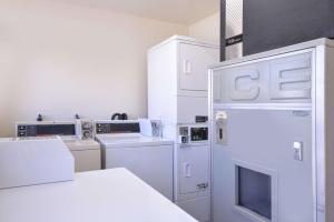 a kitchen with white appliances and a refrigerator at Bishop Inn in Bishop