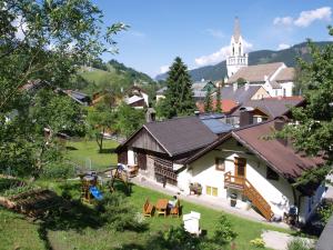 a small village with a church in the background at Simonegg in Schladming