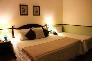 Cama ou camas em um quarto em Hotel Capim Limão Itaipava
