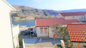 a house with a stop sign next to a street at Apartments Niko Metajna, island Pag in Metajna