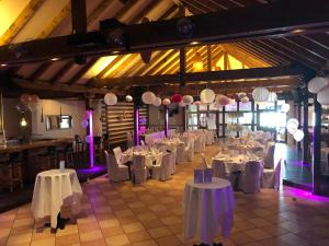 a room filled with tables and chairs with white table cloth at Burbaums Restaurant Hotel in Waltrop