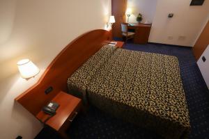 Postel nebo postele na pokoji v ubytování Hotel da Roberto