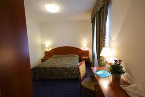 Postel nebo postele na pokoji v ubytování Hotel da Roberto