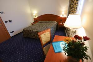 Postel nebo postele na pokoji v ubytování Hotel da Roberto