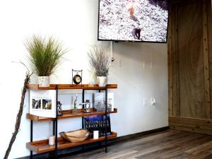 a living room with a television on a wall at The Aspen in West Yellowstone