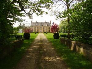 a large house in the middle of a field at Le domaine de Beaufai in Beaufai