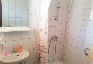 a bathroom with a shower and a sink at Apartments Niko Metajna, island Pag in Metajna