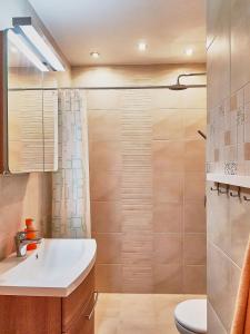 a bathroom with a sink and a shower at seeYOU apartment Balatonfüred in Balatonfüred