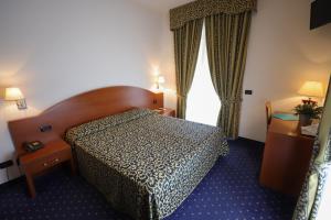 Postel nebo postele na pokoji v ubytování Hotel da Roberto