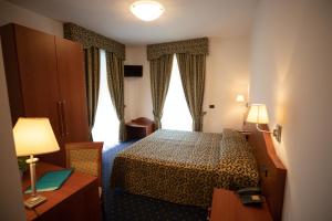 Postel nebo postele na pokoji v ubytování Hotel da Roberto