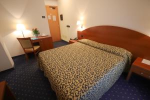 Postel nebo postele na pokoji v ubytování Hotel da Roberto