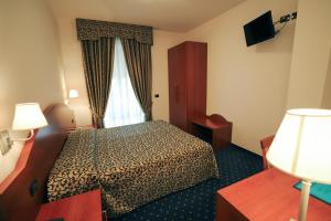 Postel nebo postele na pokoji v ubytování Hotel da Roberto