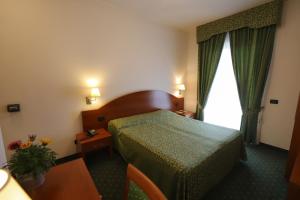 Postel nebo postele na pokoji v ubytování Hotel da Roberto