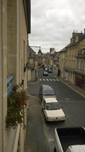 a street with cars parked on the side of the road at WELCOME Bayeux in Bayeux