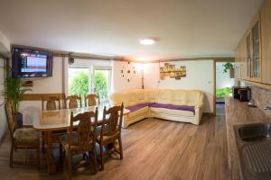 a living room with a table and a couch at Apartma na Ravnicah in Cerkno