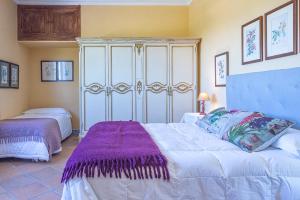a bedroom with two beds and a dresser at Alterhome Private Villa Cortijo Sierra y Lago in Arcos de la Frontera