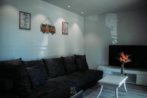 a living room with a couch and a tv at WE ARE HOSTEL in Póvoa de Varzim