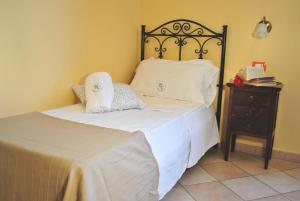 a bedroom with a bed with white sheets and pillows at Hotel Columbia in Palermo