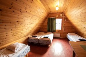 a room with two beds in a log cabin at Ranua Resort Camping Ranuanjärvi in Ranua +25 photos