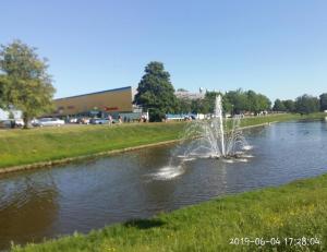 a fountain in the middle of a pond at Vidumgrāvja apartamenti in Ventspils