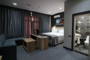 ein Hotelzimmer mit einem Bett und einem Bad in der Unterkunft Home Suites Baku-Halal Hotel in Baku