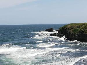 a view of the ocean with a rocky coastline at Sweet Suite Sinemorets in Sinemorets